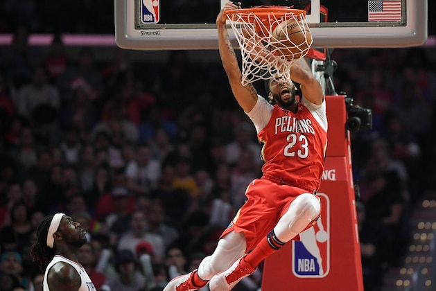 New Orleans Pelicans forward Anthony Davis, right, dunks as Los Angeles Clippers forward Montrezl Harrell watches during the second half of an NBA basketball game, Monday, April 9, 2018, in Los Angeles. The Pelicans won 113-100. (AP Photo/Mark J. Terrill)