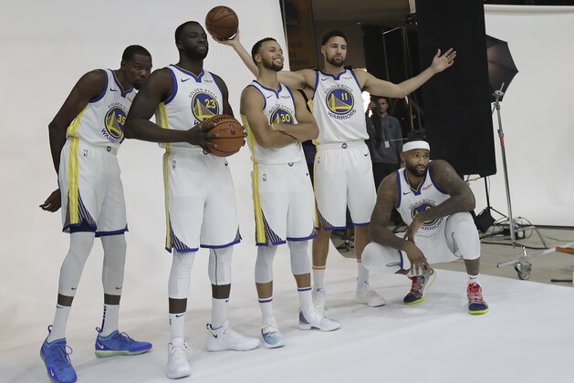 Golden State Warriors' Kevin Durant, from left, Draymond Green, Stephen Curry, Klay Thompson and DeMarcus Cousins poses for photos for the team's photographer during media day at the NBA basketball team's practice facility in Oakland, Calif., Monday, Sept. 24, 2018. (AP Photo/Jeff Chiu)