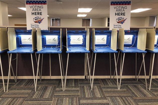 Voting booths stand ready in downtown Minneapolis on Thursday, Sept. 20, 2018, for Friday's opening of early voting in Minnesota. Minnesota and South Dakota are tied for the earliest start in the country for early voting in the 2018 midterm elections. (AP Photo/Steve Karnowski)