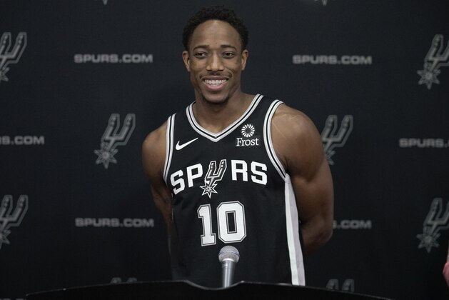 San Antonio Spurs guard DeMar DeRozan answers questions from reporters during media day at the Spurs NBA basketball practice facility in San Antonio, Monday, Sept. 24, 2018. (AP Photo/Darren Abate)