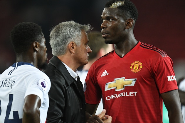 Manchester United's Portuguese manager Jose Mourinho (C) greets Manchester United's French midfielder Paul Pogba (R) after the final whistle in the English Premier League football match between Manchester United and Tottenham Hotspur at Old Trafford in Manchester, north west England, on August 27, 2018. (Photo by Oli SCARFF / AFP) / RESTRICTED TO EDITORIAL USE. No use with unauthorized audio, video, data, fixture lists, club/league logos or 'live' services. Online in-match use limited to 120 images. An additional 40 images may be used in extra time. No video emulation. Social media in-match use limited to 120 images. An additional 40 images may be used in extra time. No use in betting publications, games or single club/league/player publications. /         (Photo credit should read OLI SCARFF/AFP/Getty Images)