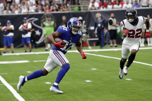New York Giants wide receiver Sterling Shepard (87) runs with ball as Houston Texans defensive back Aaron Colvin (22) defends during the first half of an NFL football game Sunday, Sept. 23, 2018, in Houston. (AP Photo/Michael Wyke)