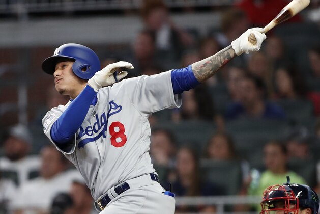 Los Angeles Dodgers' Manny Machado follows through on a solo home run in the sixth inning against Atlanta Braves in a baseball game Thursday, July 26, 2018 in Atlanta. (AP Photo/John Bazemore)