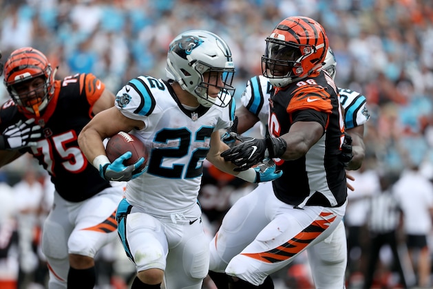 CHARLOTTE, NC - SEPTEMBER 23:  Christian McCaffrey #22 of the Carolina Panthers runs the ball against Carlos Dunlap #96 of the Cincinnati Bengals in the fourth quarter during their game at Bank of America Stadium on September 23, 2018 in Charlotte, North Carolina.  (Photo by Streeter Lecka/Getty Images)
