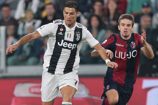 TURIN, ITALY - SEPTEMBER 26:  Cristiano Ronaldo of Juventus FC is challenged by Adam Nagy (R) of Bologna FC during the Serie A match between Juventus and Bologna FC at Allianz Stadium on September 26, 2018 in Turin, Italy.  (Photo by Emilio Andreoli/Getty Images)