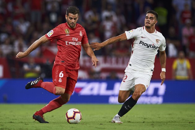 SEVILLE, SPAIN - SEPTEMBER 26:  Nacho Fernandez of Real Madrid duels for the ball with Andre Silva of Sevilla FC during the La Liga match between Sevilla FC and Real Madrid CF at Estadio Ramon Sanchez Pizjuan on September 26, 2018 in Seville, Spain.  (Photo by Aitor Alcalde/Getty Images)