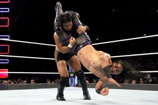 Mustafa Ali hitting a hurricanrana on Hideo Itami