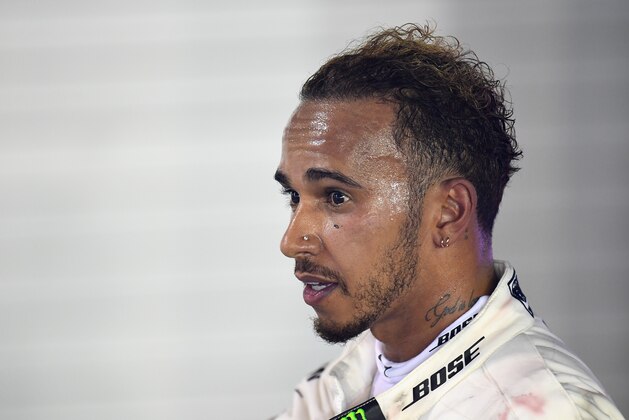 SINGAPORE - SEPTEMBER 16:  Race winner Lewis Hamilton of Great Britain and Mercedes GP celebrates in parc ferme during the Formula One Grand Prix of Singapore at Marina Bay Street Circuit on September 16, 2018 in Singapore.  (Photo by Clive Mason/Getty Images)