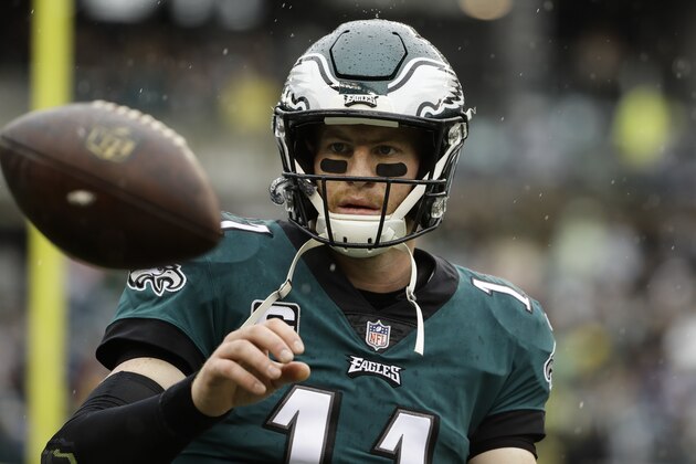 FILE - In this Sunday, Sept. 23, 2018 file photo,Philadelphia Eagles quarterback Carson Wentz (11) ahead of an NFL football game the Indianapolis Colts in Philadelphia. The Eagles visit the Tennessee Titans hoping to have back some key players on offense and Carson Wentz getting more comfortable in his second game back from his own torn ACL. Tennessee expects quarterback Marcus Mariota to start his first game since hurting the elbow on his right, throwing arm in the season opener. (AP Photo/Matt Rourke, File)