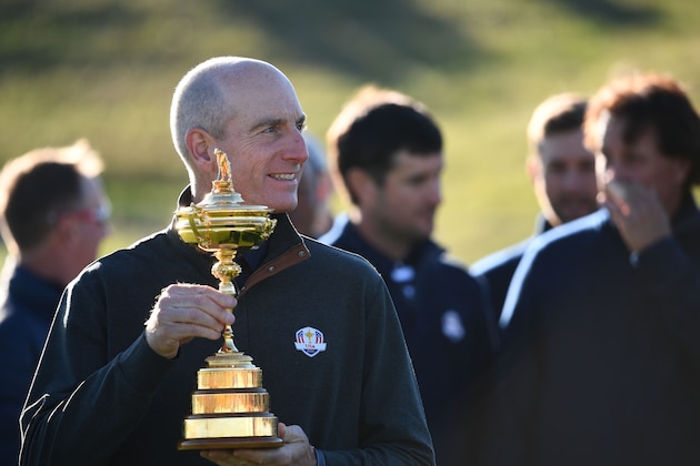 US team captain Jim Furyk holds the trophy as he takes part in a team photograph ahead of the 42nd Ryder Cup at Le Golf National Course at Saint-Quentin-en-Yvelines, south-west of Paris on September 26, 2018. (Photo by FRANCK FIFE / AFP)        (Photo credit should read FRANCK FIFE/AFP/Getty Images)