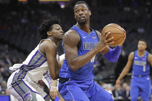 Dallas Mavericks forward Harrison Barnes (40) works for position against Sacramento Kings guard De'Aaron Fox (5) during the first half of an NBA basketball game in Sacramento, Calif., Tuesday, March 27, 2018. (AP Photo/Steve Yeater)