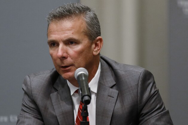 FILE - In this Aug. 22, 2018, file photo, Ohio State football coach Urban Meyer makes a statement during a news conference in Columbus, Ohio. Meyer’s current suspension and previous paid leave have restricted him from talking football with his staff and athletes during August with one exception _ a team meeting the day after the suspension was announced. Emails from the senior vice president for human resources show Meyer and athletic director Gene Smith were allowed to meet with the players and coaches last Thursday, Aug. 23, 2018. (AP Photo/Paul Vernon, File)