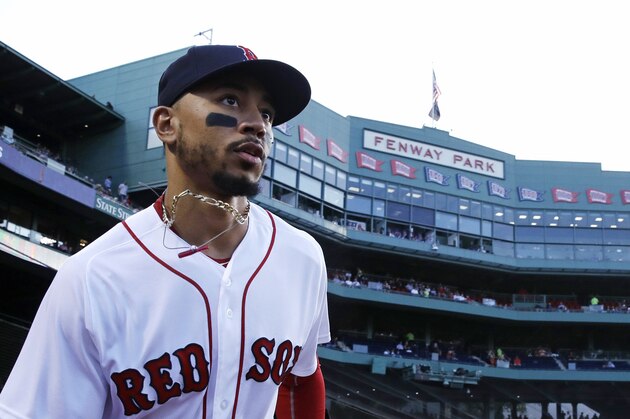 Boston Red Sox right fielder Mookie Betts runs onto the field to warm up prior to a baseball game at Fenway Park in Boston, Monday, Aug. 20, 2018. (AP Photo/Charles Krupa)