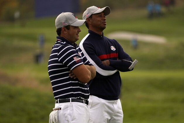 US golfer Tiger Woods (R) and US golfer Patrick Reed react during their fourball match on the first day of the 42nd Ryder Cup at Le Golf National Course at Saint-Quentin-en-Yvelines, south-west of Paris on September 28, 2018. (Photo by Lionel BONAVENTURE / AFP)        (Photo credit should read LIONEL BONAVENTURE/AFP/Getty Images)