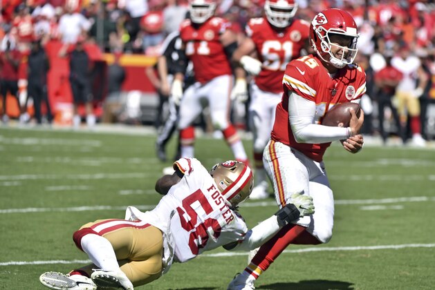 Kansas City Chiefs quarterback Patrick Mahomes (15) runs past San Francisco 49ers linebacker Reuben Foster (56) during the first half of an NFL football game in Kansas City, Mo., Sunday, Sept. 23, 2018. (AP Photo/Ed Zurga)