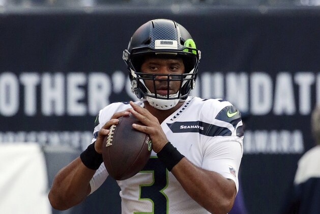 Seattle Seahawks quarterback Russell Wilson (3) warms up before an NFL football game against the Chicago Bears Monday, Sept. 17, 2018, in Chicago. (AP Photo/David Banks)