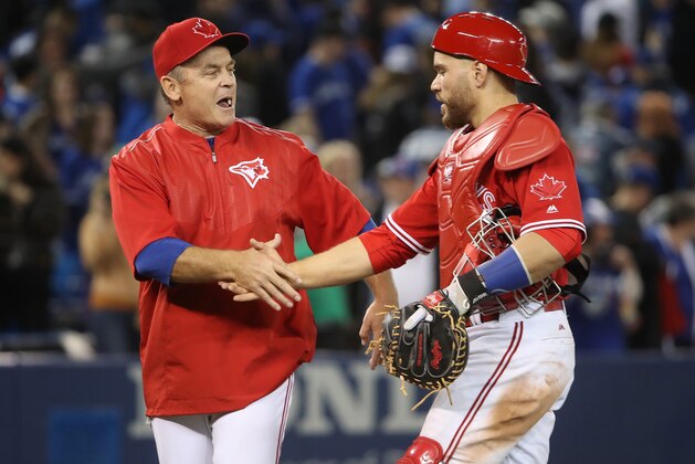 TORONTO, ON - APRIL 30: Russell Martin #55 of the Toronto Blue Jays is congratulated on their victory by manager John Gibbons #5 during MLB game action against the Tampa Bay Rays at Rogers Centre on April 30, 2017 in Toronto, Canada. (Photo by Tom Szczerbowski/Getty Images)