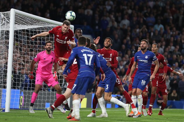 Liverpool's Scottish defender Andrew Robertson (2l) heads the ball away during the English Premier League football match between Chelsea and Liverpool at Stamford Bridge in London on September 29, 2018. (Photo by Daniel LEAL-OLIVAS / AFP) / RESTRICTED TO EDITORIAL USE. No use with unauthorized audio, video, data, fixture lists, club/league logos or 'live' services. Online in-match use limited to 120 images. An additional 40 images may be used in extra time. No video emulation. Social media in-match use limited to 120 images. An additional 40 images may be used in extra time. No use in betting publications, games or single club/league/player publications. /         (Photo credit should read DANIEL LEAL-OLIVAS/AFP/Getty Images)