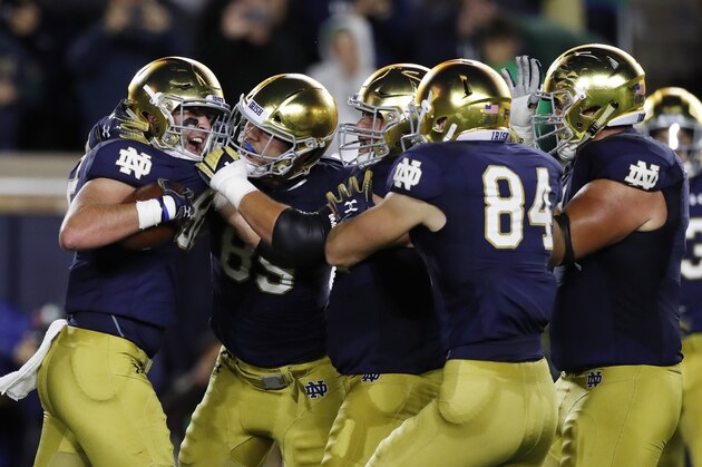 Notre Dame tight end Nic Weishar, left, is greeted by teammates after a 6-yard reception for a touchdown during the first half of an NCAA college football game Saturday, Sept. 29, 2018, in South Bend, Ind. (AP Photo/Carlos Osorio)