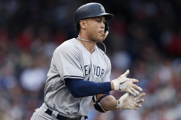 New York Yankees' Giancarlo Stanton celebrates his solo home run as he rounds first base during the seventh inning of a baseball game against the Boston Red Sox in Boston, Saturday, Sept. 29, 2018. (AP Photo/Michael Dwyer)