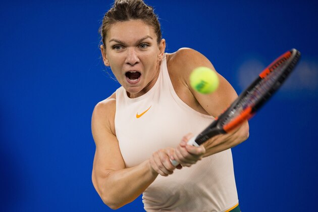 Simona Halep of Romania hits a return against Dominika Cibulkova of Slovakia during their women's singles third round match of the WTA Wuhan Open tennis tournament in Wuhan on September 25, 2018. (Photo by NICOLAS ASFOURI / AFP)        (Photo credit should read NICOLAS ASFOURI/AFP/Getty Images)