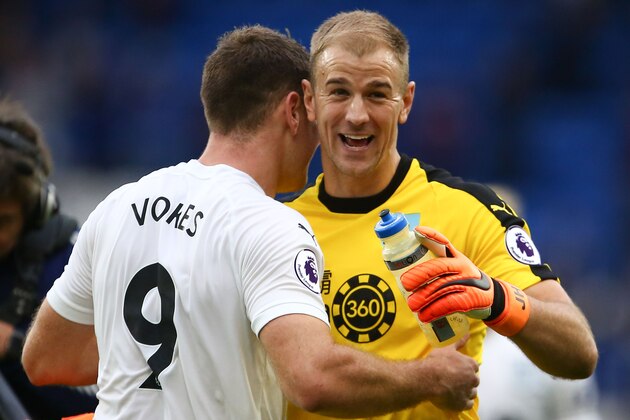 Burnley's English goalkeeper Joe Hart (R) embraces Burnley's Welsh striker Sam Vokes (L) after the final whistle during the English Premier League football match between between Cardiff City and Burnley at Cardiff City Stadium in Cardiff, south Wales on September 30, 2018. (Photo by GEOFF CADDICK / AFP) / RESTRICTED TO EDITORIAL USE. No use with unauthorized audio, video, data, fixture lists, club/league logos or 'live' services. Online in-match use limited to 120 images. An additional 40 images may be used in extra time. No video emulation. Social media in-match use limited to 120 images. An additional 40 images may be used in extra time. No use in betting publications, games or single club/league/player publications. /         (Photo credit should read GEOFF CADDICK/AFP/Getty Images)