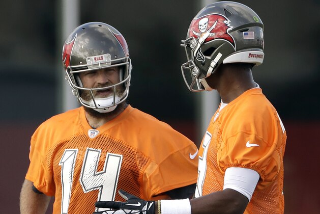 Tampa Bay Buccaneers quarterback Ryan Fitzpatrick (14) talks to quarterback Jameis Winston (3) during NFL football training camp practice Friday, July 27, 2018, in Tampa, Fla. Winston has been suspended for the first three games of the season for violating the league's conduct policy. (AP Photo/Chris O'Meara)