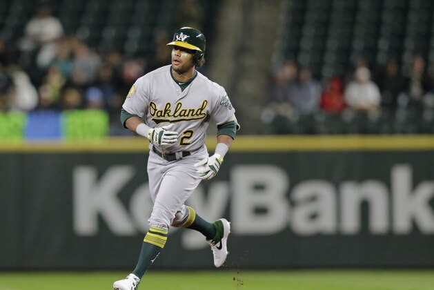 Oakland Athletics' Khris Davis rounds the bases after hitting a home run against the Seattle Mariners during a baseball game, Monday, Sept. 24, 2018, in Seattle. (AP Photo/John Froschauer)