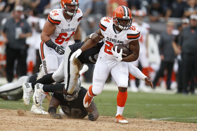 Cleveland Browns running back Nick Chubb (24) breaks a tackle attempt by Oakland Raiders defensive end Fadol Brown on a touchdown run during the second half of an NFL football game in Oakland, Calif., Sunday, Sept. 30, 2018. (AP Photo/D. Ross Cameron)