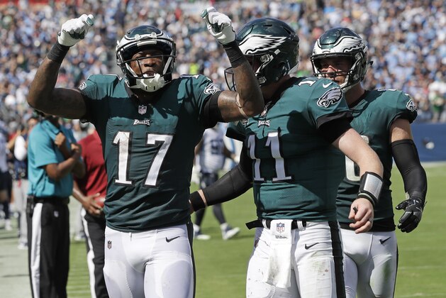 Philadelphia Eagles quarterback Carson Wentz (11) celebrates with wide receiver Alshon Jeffery (17) after they combined on a 16-yard touchdown pass against the Tennessee Titans in the second half of an NFL football game Sunday, Sept. 30, 2018, in Nashville, Tenn. (AP Photo/James Kenney)