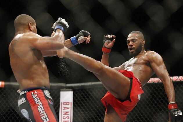FILE - This Jan. 3, 2015 file photo Jon Jones, right, kicks Daniel Cormier during their light heavyweight title mixed martial arts bout at UFC 182, in Las Vegas. Jones pleaded guilty Tuesday, Sept. 29, to a charge stemming from a hit-and-run crash in Albuquerque that injured a pregnant woman, saying he took full responsibility for what the judge called a “stupid decision” in the moments following the accident. (AP Photo/John Locher, File)