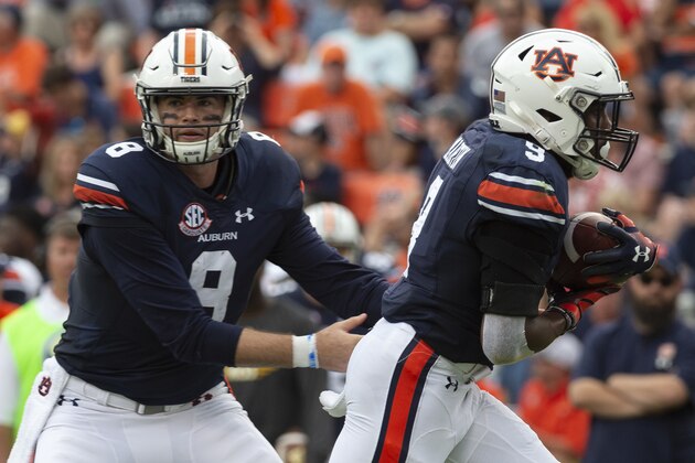 Auburn quarterback Jarrett Stidham (8) hands off to Auburn running back Kam Martin (9) against Southern Miss during the first half of an NCAA college football game, Saturday, Sept. 29, 2018, in Auburn, Ala. (AP Photo/Vasha Hunt)