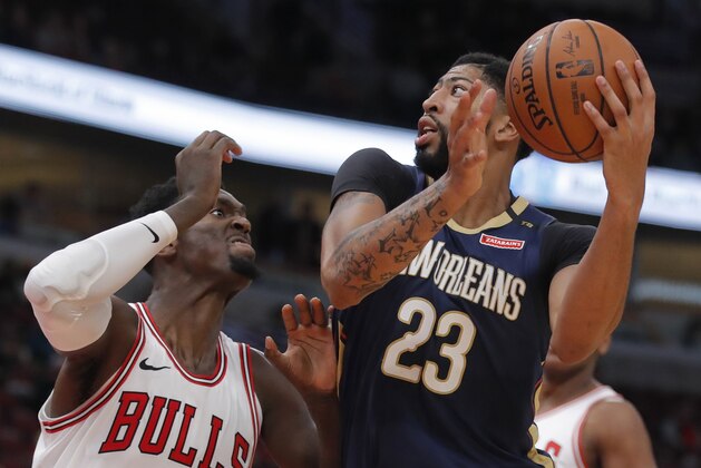 New Orleans Pelicans' Anthony Davis, right, goes to the basket against Chicago Bulls' Bobby Portis during the first half of a preseason NBA basketball game Sunday, Sept. 30, 2018, in Chicago. (AP Photo/Jim Young)