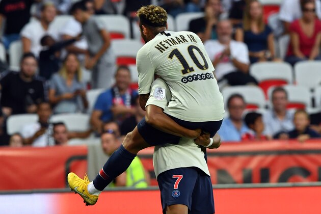 Paris Saint-Germain's Brazilian forward Neymar (C) celebrates  with Paris Saint-Germain's French forward Kylian Mbappe after scoring a goal during the French L1 football match Nice (OGCN) vs Paris (PSG) on September 29, 2018 at 'Allianz Riviera' stadium in Nice, southern France. (Photo by Yann COATSALIOU / AFP)        (Photo credit should read YANN COATSALIOU/AFP/Getty Images)