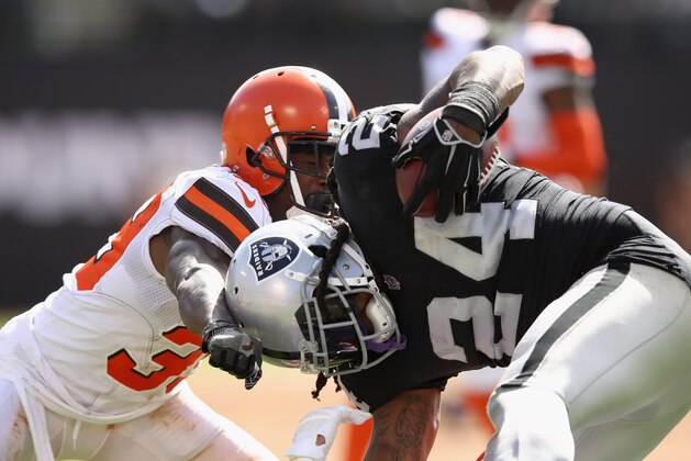 OAKLAND, CA - SEPTEMBER 30:  Marshawn Lynch #24 of the Oakland Raiders is tackled by Terrance Mitchell #39 of the Cleveland Browns at Oakland-Alameda County Coliseum on September 30, 2018 in Oakland, California.  (Photo by Ezra Shaw/Getty Images)