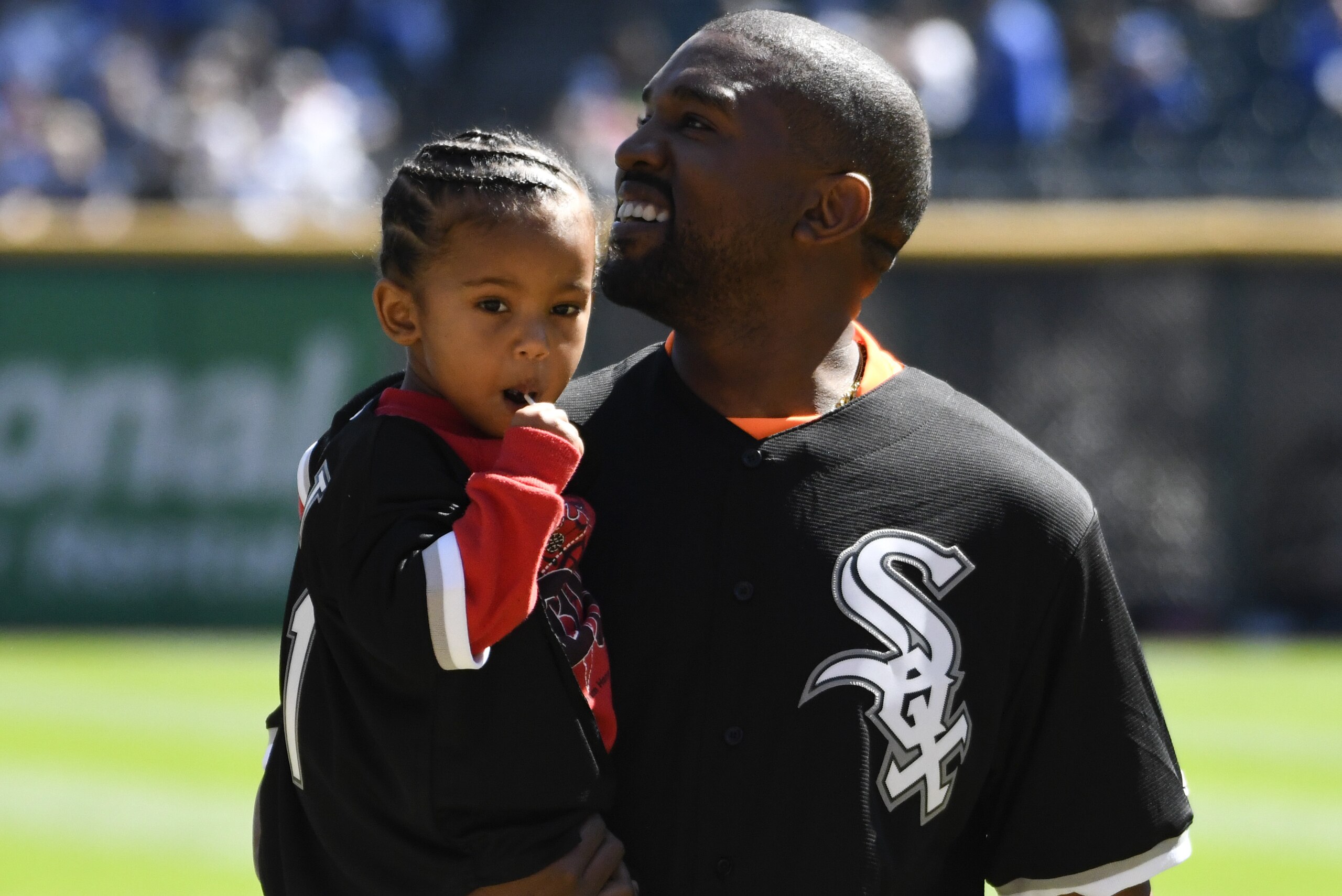CHICAGO, IL - SEPTEMBER 23: Kanye West and his son Saint after throwing out a ceremonial first pitch before the game between the Chicago White Sox and the Chicago Cubs on September 23, 2018 at Guaranteed Rate Field  in Chicago, Illinois. (Photo by David Banks/Getty Images)