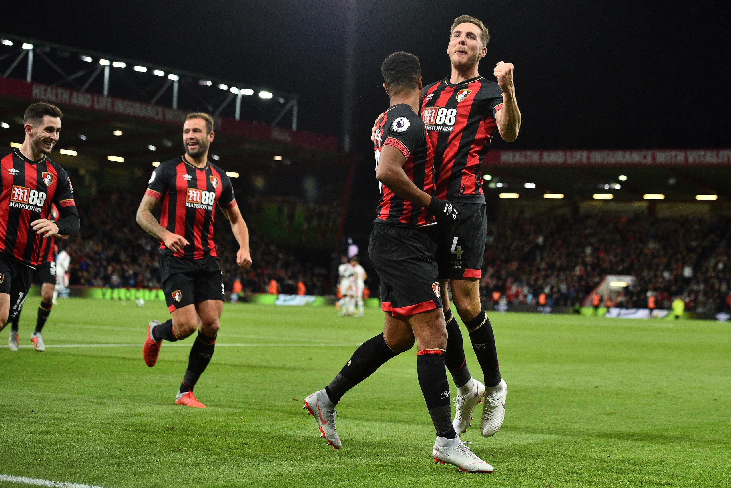 Bournemouth's English midfielder Junior Stanislas (2R) celebrates scoring his team's second goal from the penalty spot during the English Premier League football match between Bournemouth and Crystal Palace at the Vitality Stadium in Bournemouth, southern England on October 1, 2018. (Photo by Glyn KIRK / AFP) / RESTRICTED TO EDITORIAL USE. No use with unauthorized audio, video, data, fixture lists, club/league logos or 'live' services. Online in-match use limited to 120 images. An additional 40 images may be used in extra time. No video emulation. Social media in-match use limited to 120 images. An additional 40 images may be used in extra time. No use in betting publications, games or single club/league/player publications. /         (Photo credit should read GLYN KIRK/AFP/Getty Images)