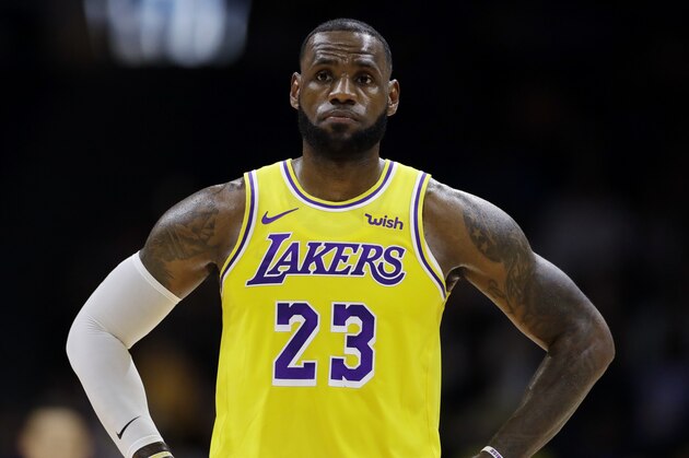Los Angeles Lakers forward LeBron James looks on during the first half of an NBA preseason basketball game against the Denver Nuggets Sunday, Sept. 30, 2018, in San Diego. (AP Photo/Gregory Bull)