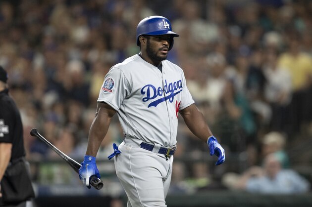 Los Angeles Dodgers' Yasiel Puig walks off the field after an at-bat during a baseball game against the Seattle Mariners, Saturday, Aug. 18, 2018, in Seattle. The Mariners won 5-4 in 10 innings. (AP Photo/Stephen Brashear)