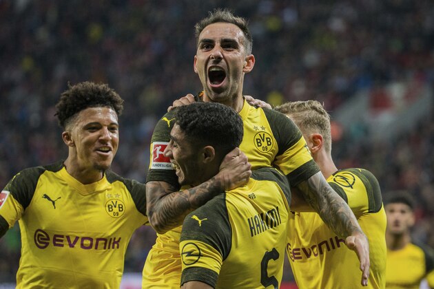 In this Sept. 29, 2018 photo Dortmund's Paco Alcacer, top, celebrates with Achraf Hakim, front, and Jadon Sancho after scoring his side's third goal in the German Bundesliga soccer match between Bayer 04 Leverkusen and Borussia Dortmund. (Rolf Vennenbernd/dpa via AP) In this Sept. 29, 2018 photo Dortmund's Paco Alcacer, top, celebrates with Achraf Hakim, front, and Jadon Sancho after scoring his side's third goal in the German Bundesliga soccer match between Bayer 04 Leverkusen and Borussia Dortmund. (Rolf Vennenbernd/dpa via AP)