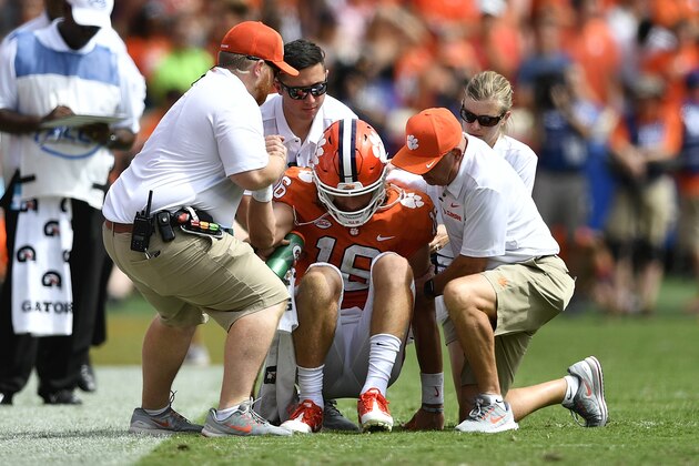 CLEMSON, SC - SEPTEMBER 29: Quarterback Trevor Lawrence #16 of the Clemson Tigers is helped from the field after taking a hard hit from the Syracuse Orange during the football game at Clemson Memorial Stadium on September 29, 2018 in Clemson, South Carolina. (Photo by Mike Comer/Getty Images)
