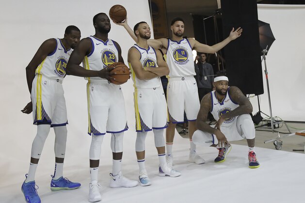 Golden State Warriors' Kevin Durant, from left, Draymond Green, Stephen Curry, Klay Thompson and DeMarcus Cousins poses for photos for the team's photographer during media day at the NBA basketball team's practice facility in Oakland, Calif., Monday, Sept. 24, 2018. (AP Photo/Jeff Chiu)