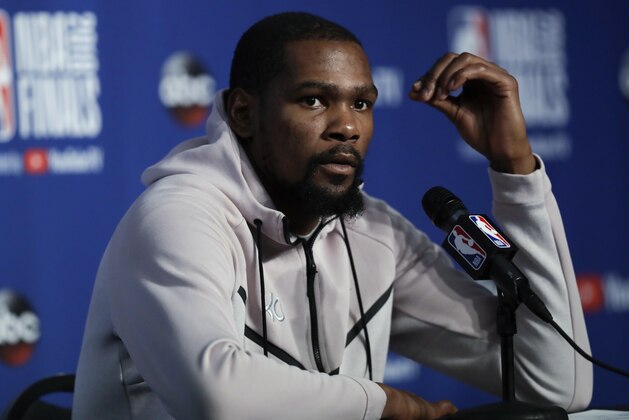Golden State Warriors forward Kevin Durant attends a news conference following Game 3 of basketball's NBA Finals, early Wednesday June 7, 2018, in Cleveland. The Warriors defeated the Cleveland Cavaliers 110-102 to take a 3-0 lead in the series. (AP Photo/Tony Dejak)