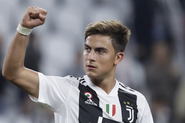 Juventus forward Paulo Dybala holds the ball after scoring a hat trick at the end of the Champions League, group H soccer match between Juventus and Young Boys, at the Allianz stadium in Turin, Italy, Tuesday, Oct. 2, 2018. (AP Photo/Luca Bruno)