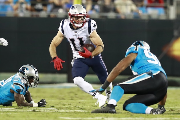 New England Patriots' Julian Edelman (11) runs as Carolina Panthers' Wes Horton (96) defends during the first half of a preseason NFL football game in Charlotte, N.C., Friday, Aug. 24, 2018. (AP Photo/Jason E. Miczek)