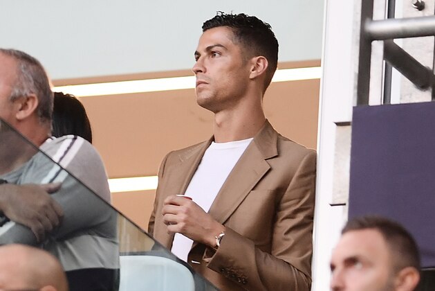 Suspended Juventus' Portuguese forward Cristiano Ronaldo (R) watches the UEFA Champions League group H football match between Juventus and Young Boys from the tribune, on October 2, 2018 at the Juventus stadium in Turin. (Photo by Marco BERTORELLO / AFP)        (Photo credit should read MARCO BERTORELLO/AFP/Getty Images)