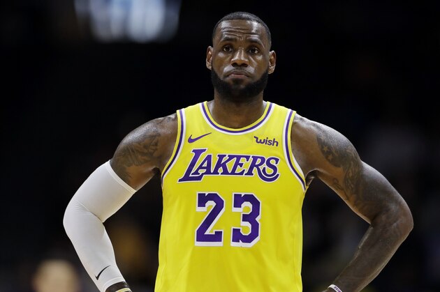 Los Angeles Lakers forward LeBron James looks on during the first half of an NBA preseason basketball game against the Denver Nuggets Sunday, Sept. 30, 2018, in San Diego. (AP Photo/Gregory Bull)