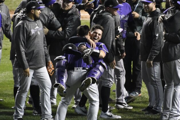 The Colorado Rockies celebrate their win against the Chicago Cubs in the National League wild-card playoff baseball game, Wednesday, Oct. 3, 2018, in Chicago. The Rockies won 2-1. (AP Photo/David Banks)