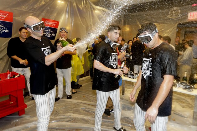 The New York Yankees celebrate in the locker room after beating the Oakland Athletics 7-2 in the American League wild-card playoff baseball game, Wednesday, Oct. 3, 2018, in New York. (AP Photo/Frank Franklin II)