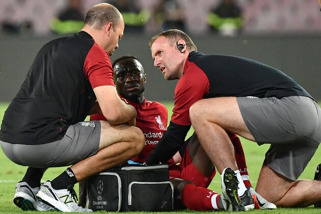 Staff medics tend to Liverpool's Guinean midfielder Naby Keita after he was injured during the UEFA Champions League group C football match between Napoli and Liverpool on October 3, 2018 at the San Paolo stadium in Naples. (Photo by Alberto PIZZOLI / AFP)        (Photo credit should read ALBERTO PIZZOLI/AFP/Getty Images)